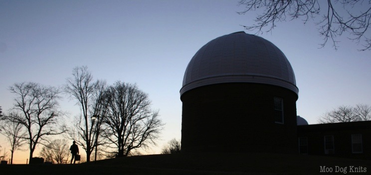 Cold, but warm wearing knitted wool sweaters - two Boston terriers - not seen in this image of an observatory at dusk - and one other walker seen. © Moo Dog Knits